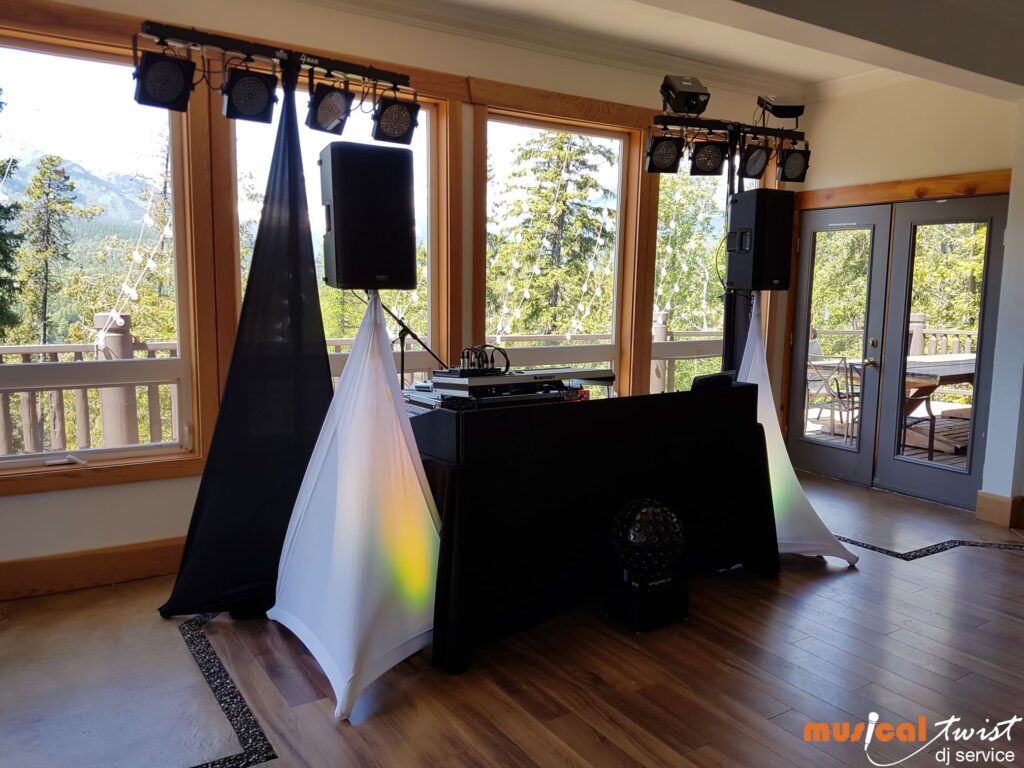 A DJ setup with speakers, and lights