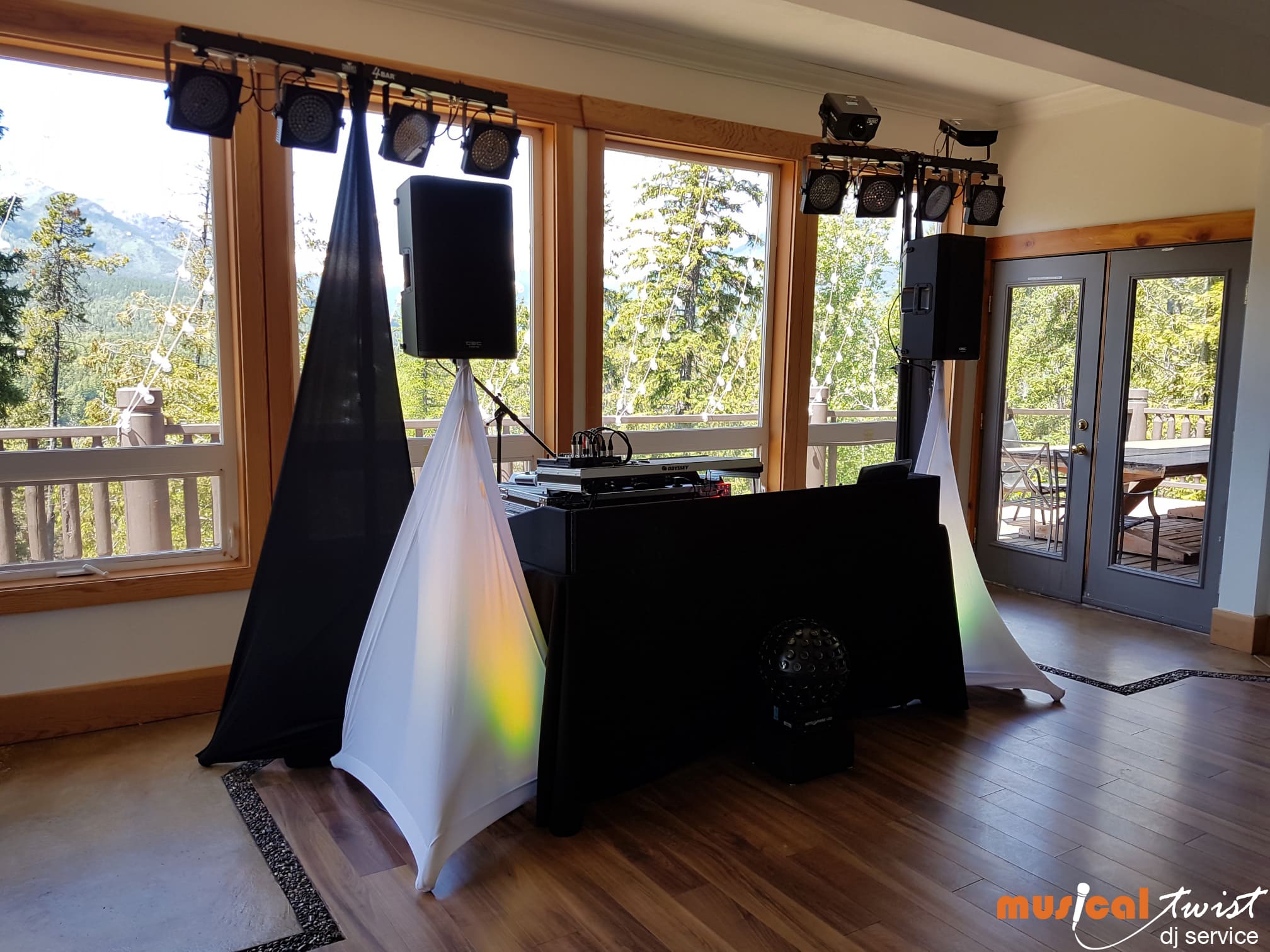 A DJ setup with speakers, and lights